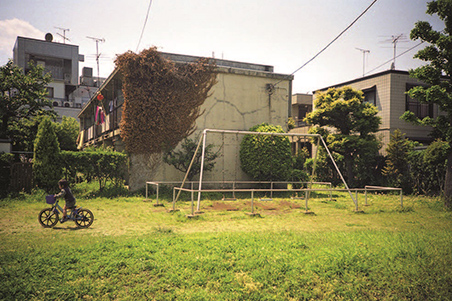 敷地内に設けられたプレイロット。背後の建物は陸屋根となっている。